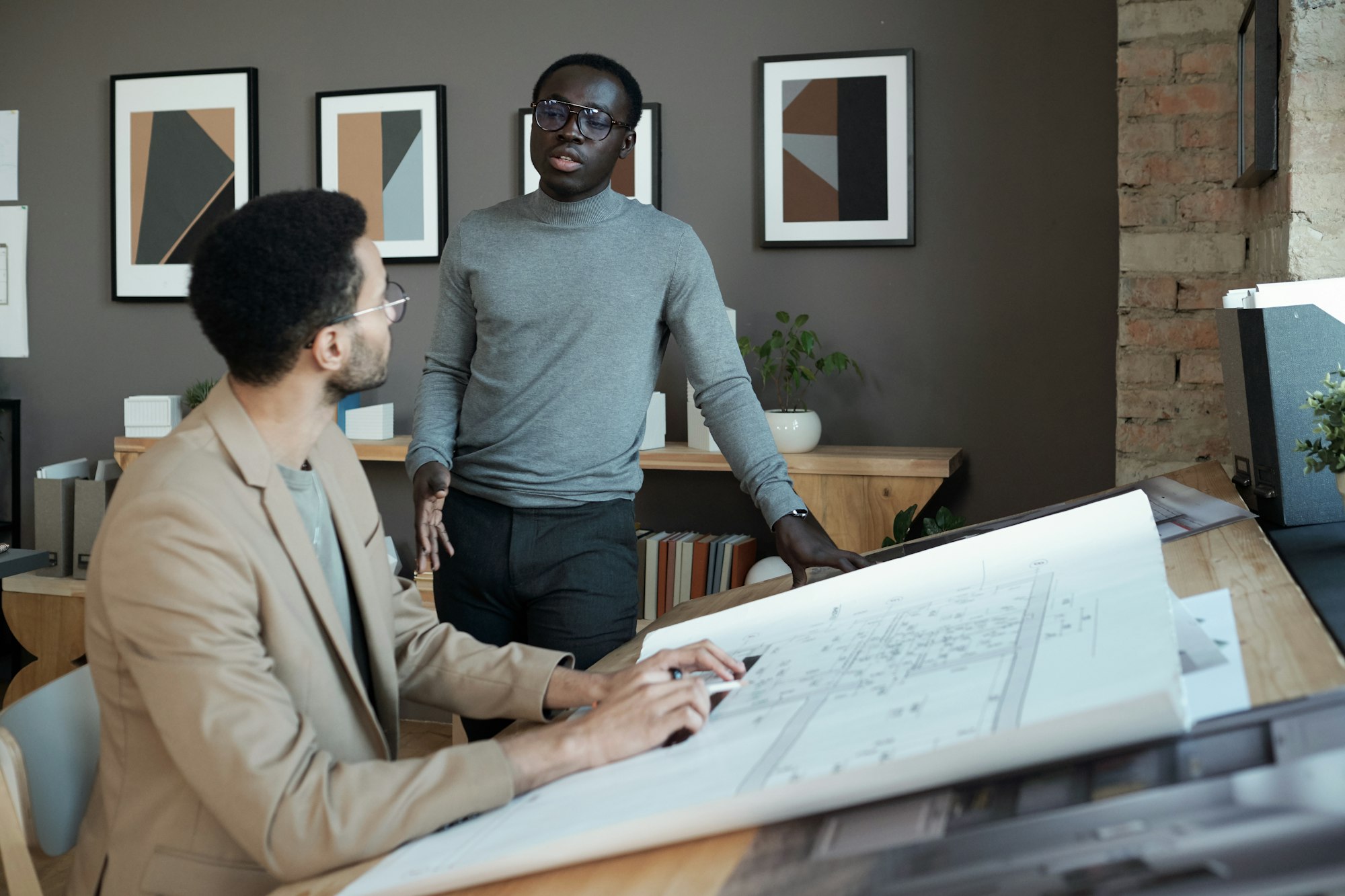 Confident African businessman consulting his biracial male colleague